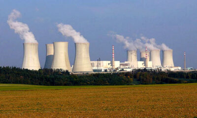 Dukovany nuclear power plant with low-lying containment buildings and tall, broad, tapered cooling towers