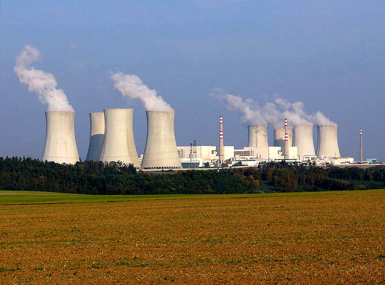 Dukovany nuclear power plant with low-lying containment buildings and tall, broad, tapered cooling towers