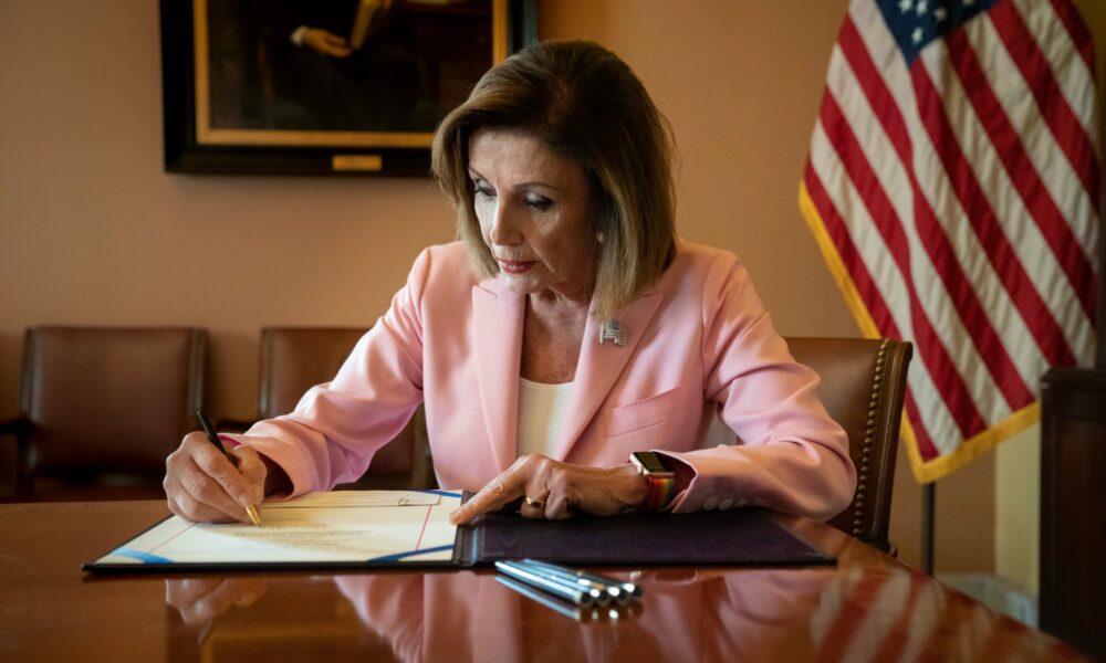 Representative Nancy Pelosi (D-Calif.), then Speaker of the House, signs legislation removing an emergency declaration
