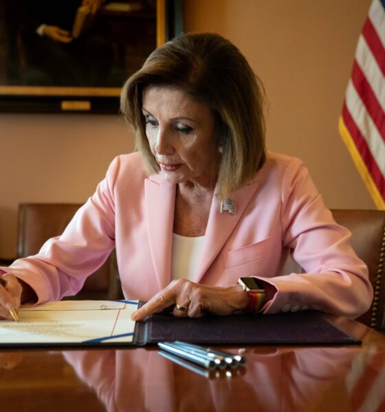 Representative Nancy Pelosi (D-Calif.), then Speaker of the House, signs legislation removing an emergency declaration