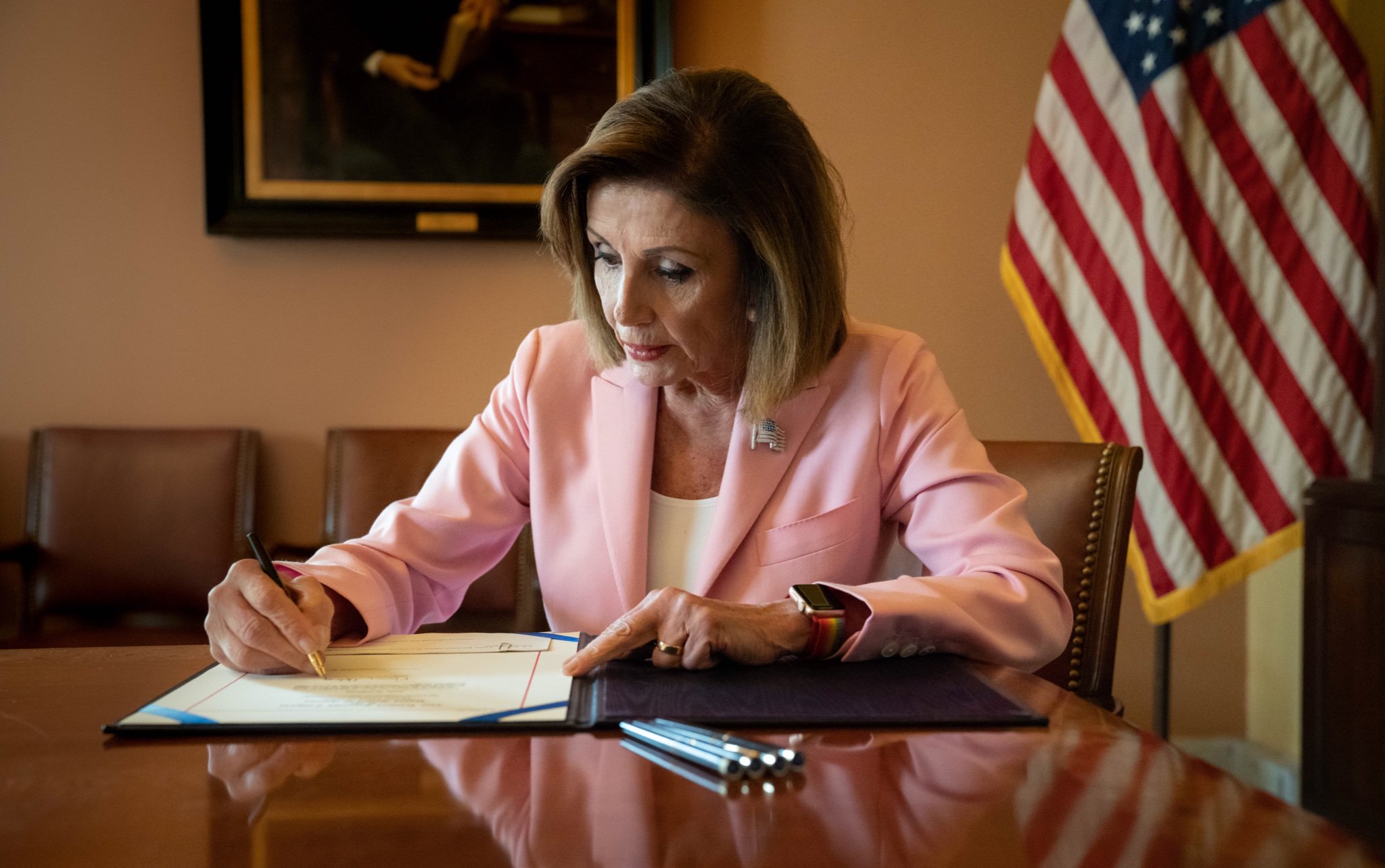 Representative Nancy Pelosi (D-Calif.), then Speaker of the House, signs legislation removing an emergency declaration