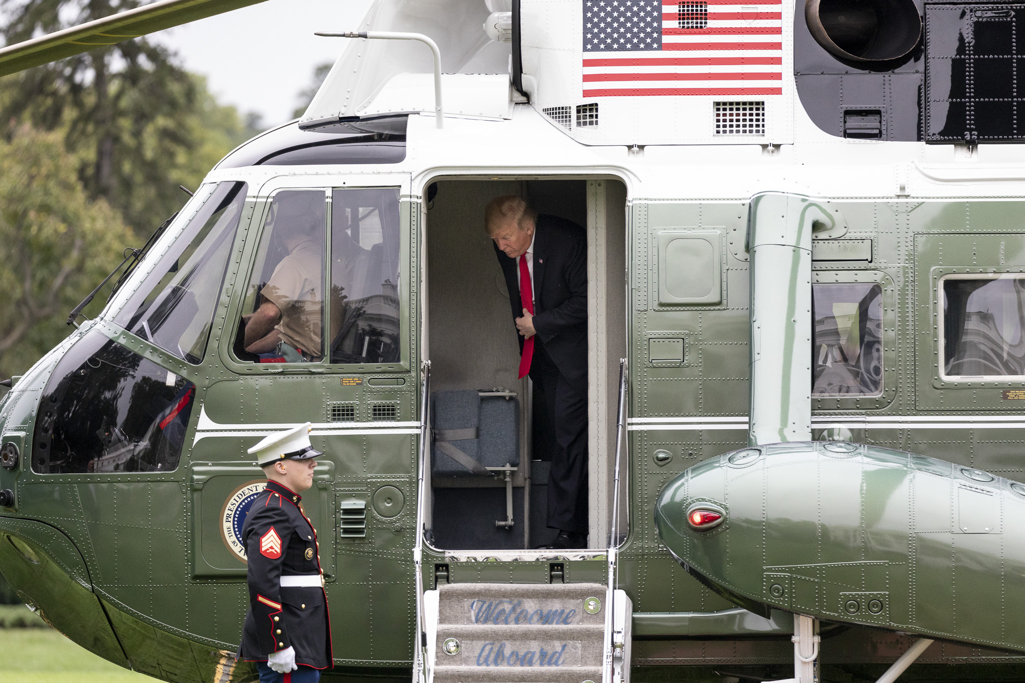 President Donald Trump aboard the Marine One VH-3D Presidential helicopter landing on the South Lawn