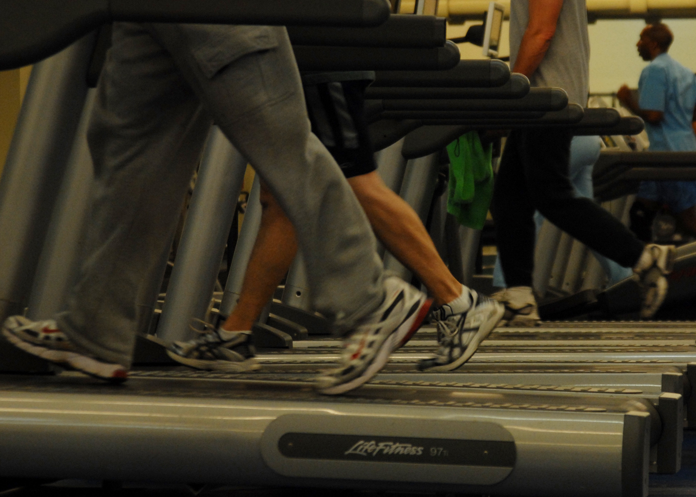 Gym members working out on treadmills