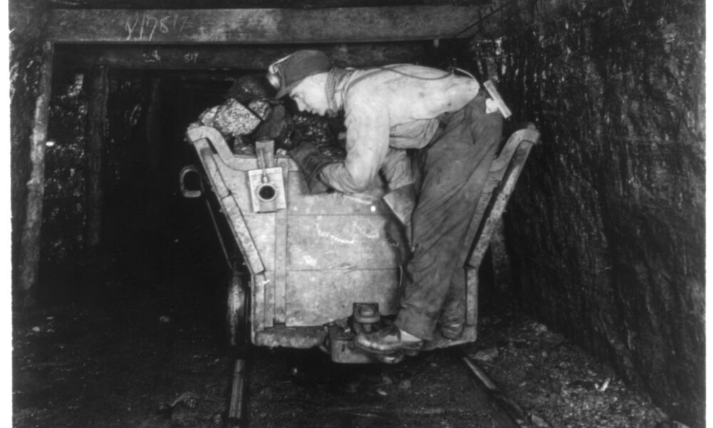 A coal miner and his equipment in the days of deep mining