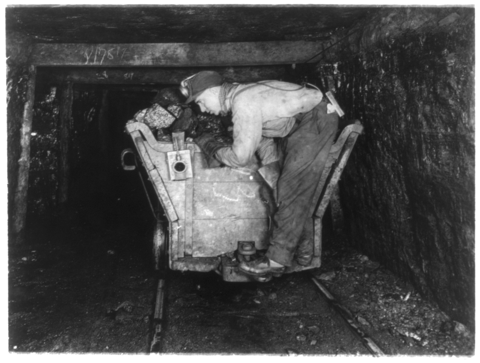 A coal miner and his equipment in the days of deep mining