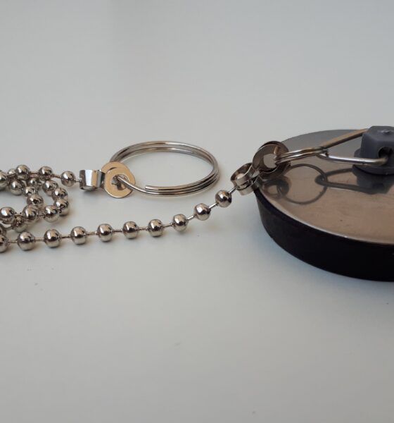 Sink drain plug with metallic top