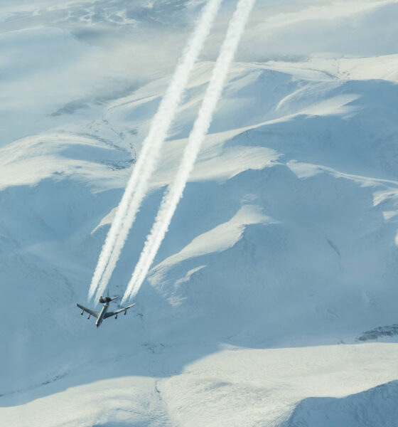The High Arctic, with an E-3 Sentry (the AWACS platform) overflying some mountains