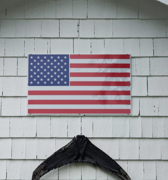 An American Flag on a shingled wall in Arlington, Massachusetts