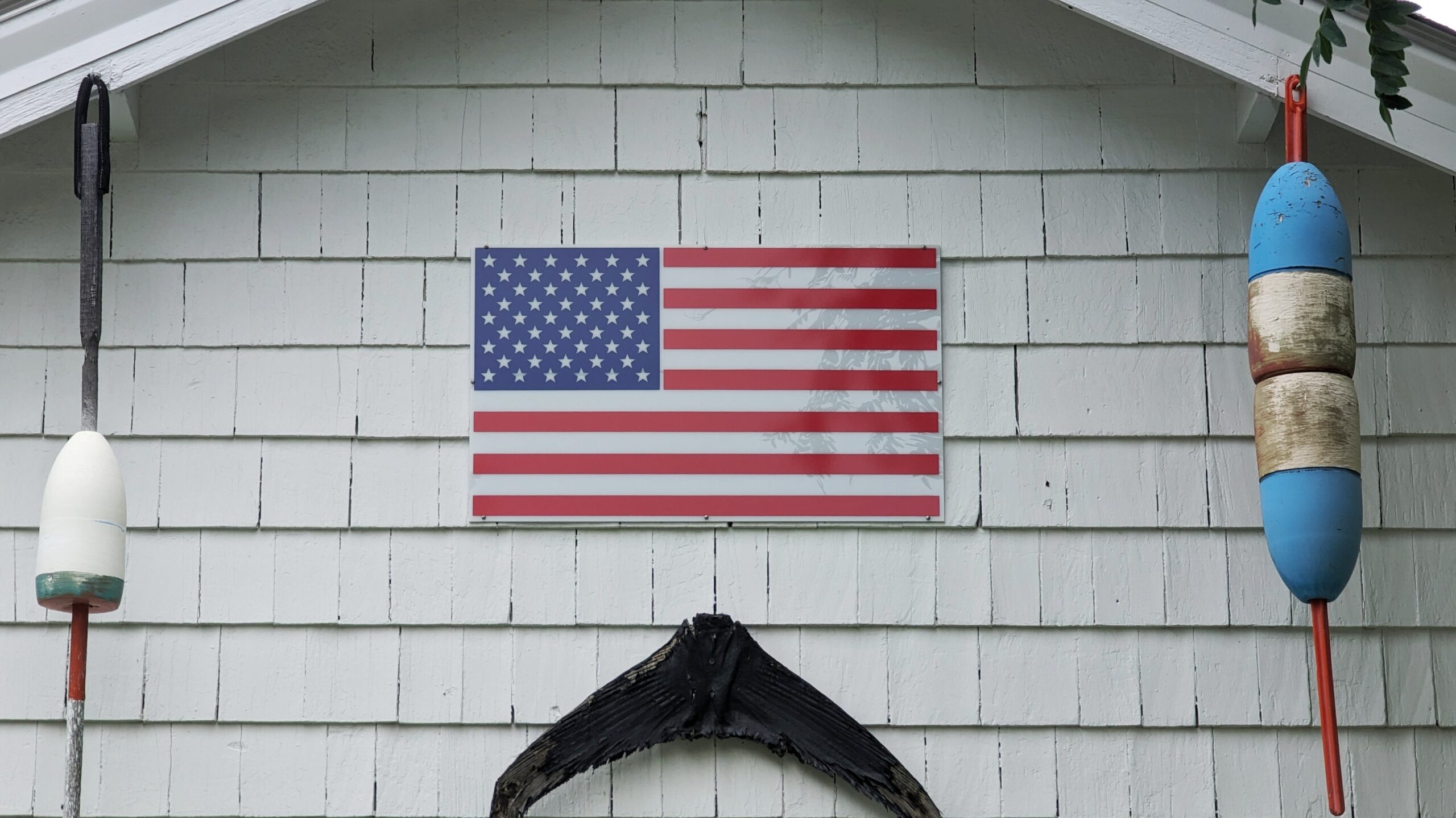 An American Flag on a shingled wall in Arlington, Massachusetts
