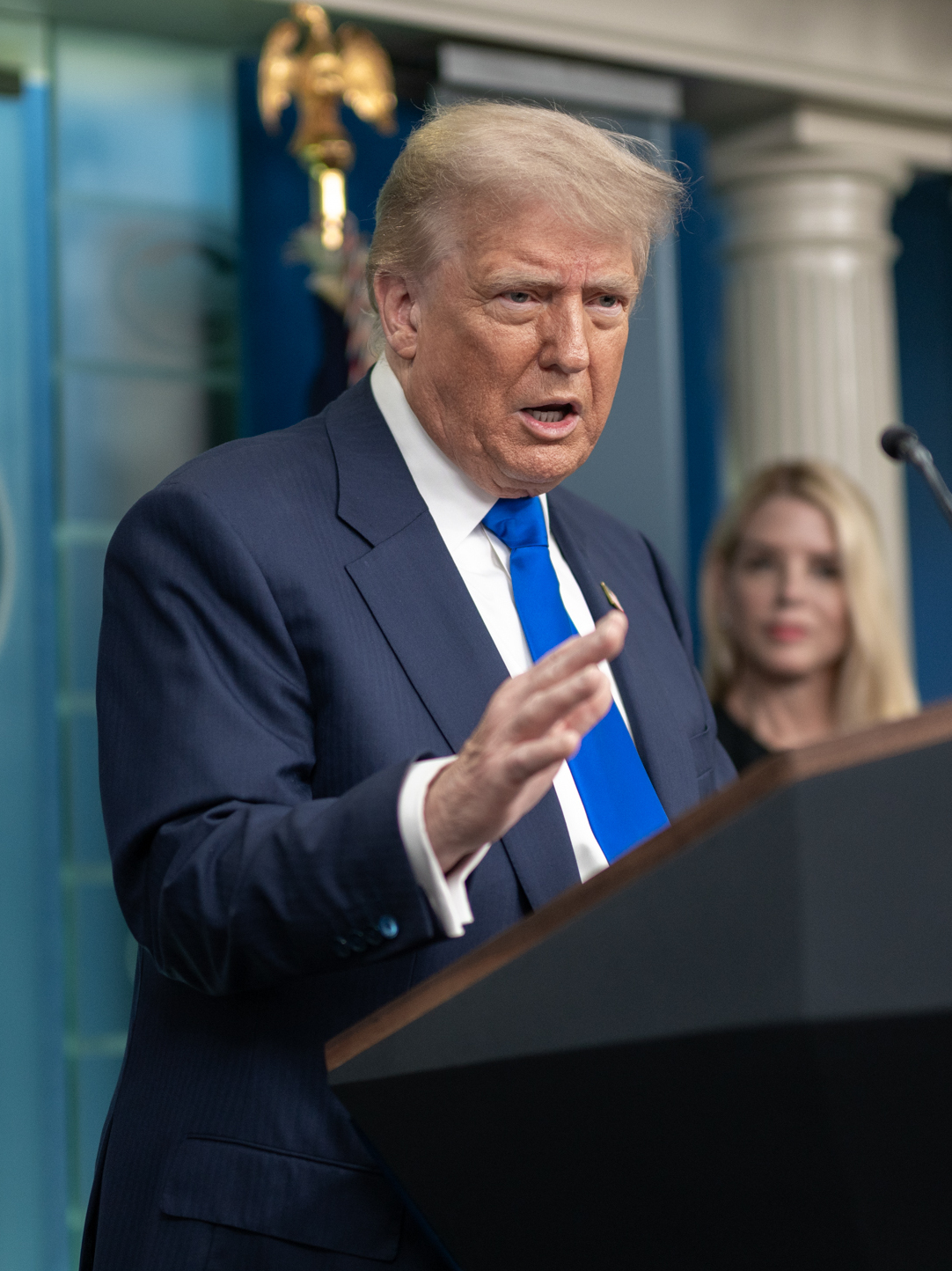 Trump holds a press conference with then Attorney General Pam Bondi in the background