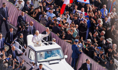 Pope Leo XIV at his inauguration, shown riding the Pope-mobile