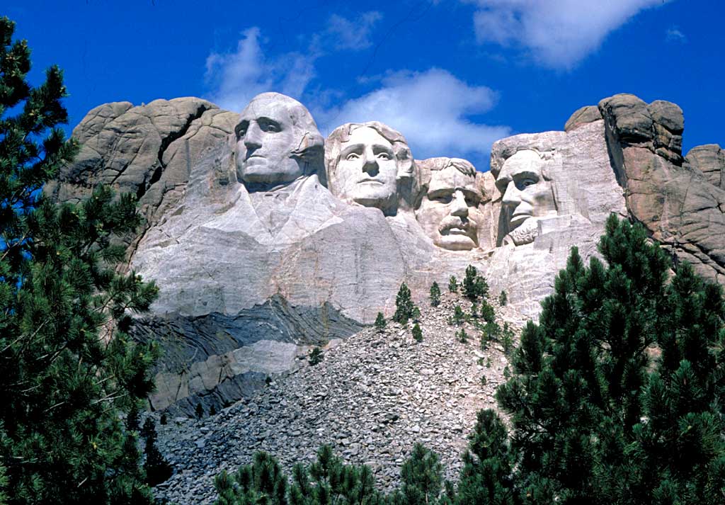 Mount Rushmore showing Presidents Washington, Jefferson, T. Roosevelt, and Lincoln (left to right)