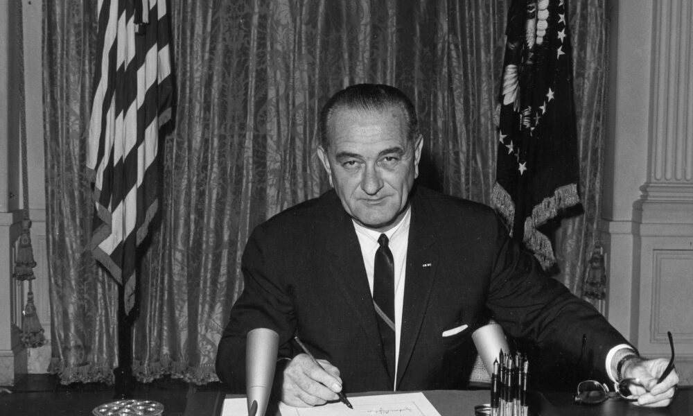 Lyndon Baines Johnson, as President, signs the Gulf of Tonkin Resolution