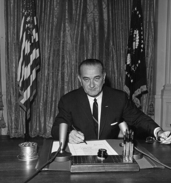 Lyndon Baines Johnson, as President, signs the Gulf of Tonkin Resolution