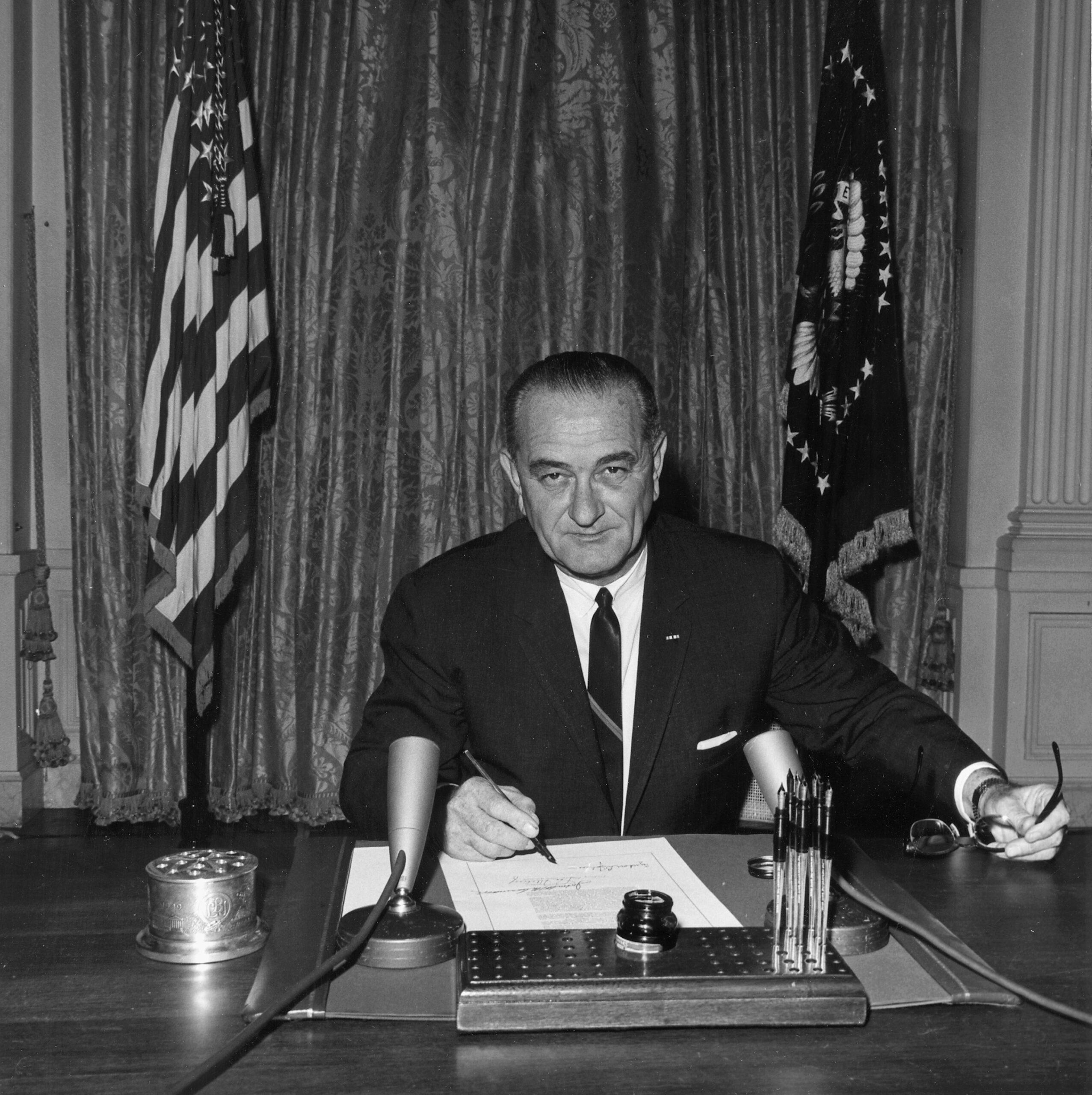 Lyndon Baines Johnson, as President, signs the Gulf of Tonkin Resolution