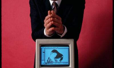 Steve Jobs, founder of Apple Computer, shown with his most famous invention, the first Apple Macintosh