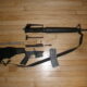 An Armalite AR-15 stripped down, showing receiver, clip, firing pin, barrel, etc.