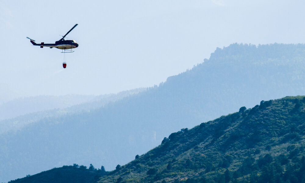 A helicopter prepares to drop water onto the Waldo Canyon Fire in Colorado Springs, Colorado in 2012