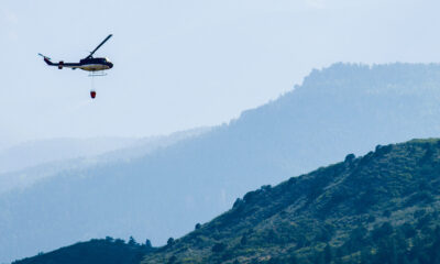 A helicopter prepares to drop water onto the Waldo Canyon Fire in Colorado Springs, Colorado in 2012