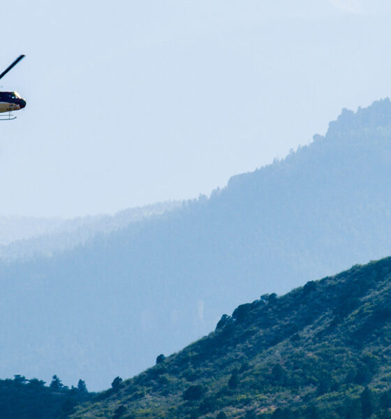 A helicopter prepares to drop water onto the Waldo Canyon Fire in Colorado Springs, Colorado in 2012