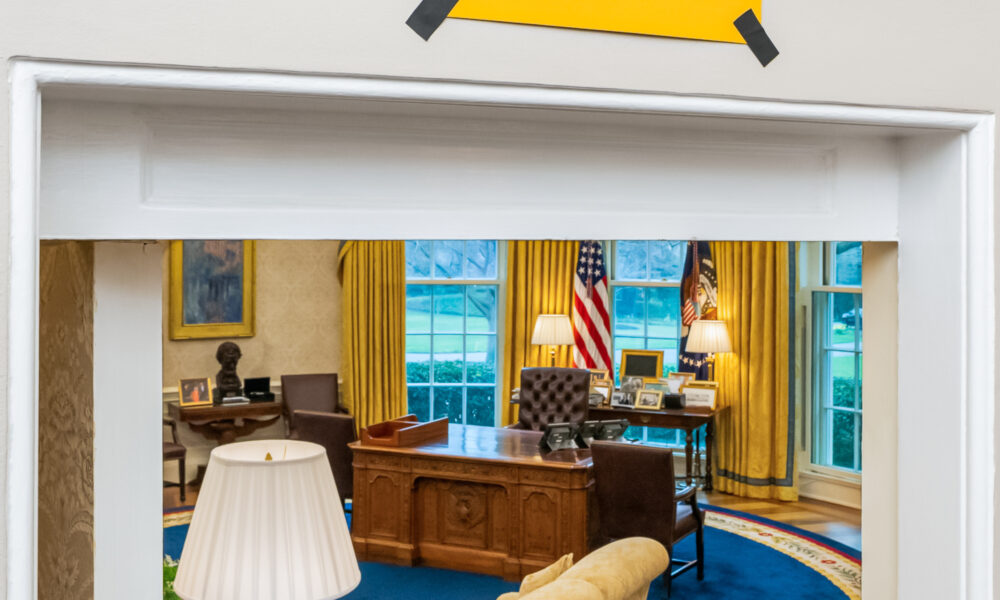 Believe sign over Oval Office door, referring to a visit from the cast of the Ted Lasso show.