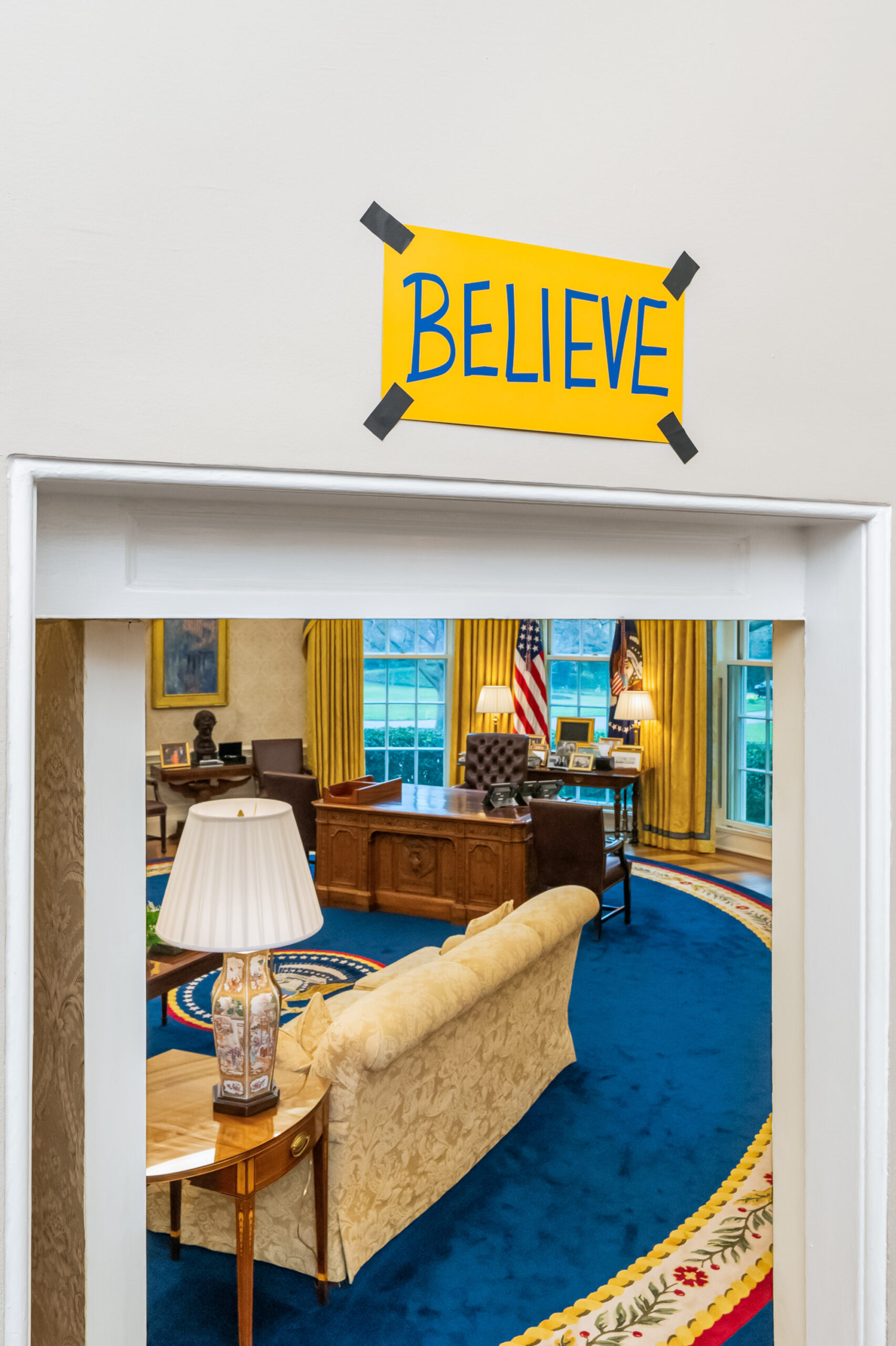 Believe sign over Oval Office door, referring to a visit from the cast of the Ted Lasso show.